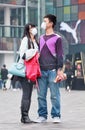 Young couple with face mask in smog blanketed city, Beijing, China