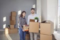 Young couple family with boxes to move in a new house room. Royalty Free Stock Photo