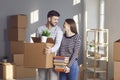 Young couple family with boxes to move in a new house room. Royalty Free Stock Photo