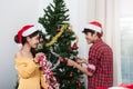 Young Couple family Decorating Christmas Tree in their Home Royalty Free Stock Photo