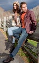 Young Couple on Fence in Mountains Royalty Free Stock Photo