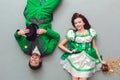 Young couple in festive costumes saint patrick`s day top view upside dow