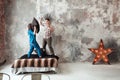 Young couple fighting pillows in the loft style bedroom Royalty Free Stock Photo