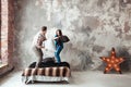 Young couple fighting pillows in the loft style bedroom Royalty Free Stock Photo