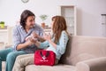 Young couple in first aid concept at home