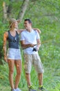 Young couple fishing on river shore in grass Royalty Free Stock Photo
