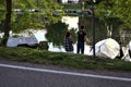 Young couple fishing by the shore of an inlet