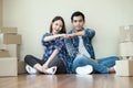 Young couple Fist Bumping sitting on floor packing boxes moving Royalty Free Stock Photo