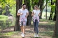 Young Couple Fitness In Sportswear Running Together In Park . Sport Man And Woman Jogging Outdoors In Nature. Workout ,exercising