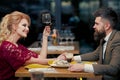 Young couple flirting in cafe drink wine. Beautiful people in love dating and drinking at restaurant. Married life. Royalty Free Stock Photo