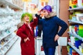 Young couple fooling around with bowls in a supermarket Royalty Free Stock Photo