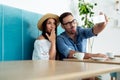 Young couple fooling around, taking selfies. - Image Royalty Free Stock Photo