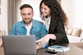 Young couple of freelancers work remotely from home - Colleagues work together making suggestions - warm filter on background