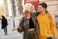 Young couple of friends near a classic British red phone booth Royalty Free Stock Photo