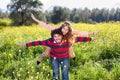 Young couple frolicking in the countryside.