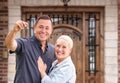 Young Couple In Front of Front Door of New House Holding Keys Royalty Free Stock Photo