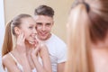 Young couple in front of mirror