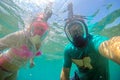 Young couple in full face masks for snorkeling making selfie under water Royalty Free Stock Photo