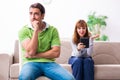 Young couple in gadget dependency concept