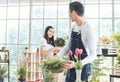 Young couple gardening plants together at home