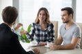 Young couple getting keys to new apartment from realtor