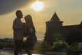 A young couple - a girl and boy sunset summer sky background. Silhouettes and shadows of people.