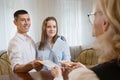 Young couple gives passports to receptionist for reserve room