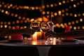 Young couple with glasses of wine having romantic candlelight dinner at table Royalty Free Stock Photo