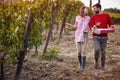 Young couple with grape in the vineyard