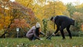 Young couple guy and girl eco-activists plant tree in park engaged in landscaping forest take care of nature environment Royalty Free Stock Photo