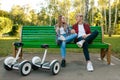 Couple with gyroboard sitting on the bench in park