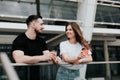 young couple handsome brunette man drinks coffee with his beautiful woman on the street, happy relationships, friendship