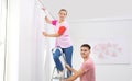 Young couple hanging window curtain indoors Royalty Free Stock Photo