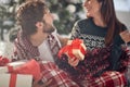 A young couple has romantic moments at home sharing Xmas presents. Christmas, relationship, love, together Royalty Free Stock Photo