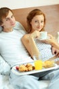 Young couple have breakfast in bed Royalty Free Stock Photo