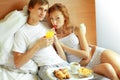 Young couple have breakfast in bed Royalty Free Stock Photo