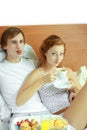 Young couple have breakfast in bed Royalty Free Stock Photo
