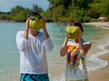 Young couple have fun closing face coconut head with sunglasses. Royalty Free Stock Photo