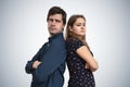 Young couple have problems. Upset man and woman standing back to back Royalty Free Stock Photo