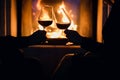 Young couple have romantic dinner with wine over fireplace background