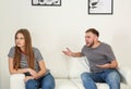 Young couple having argument in living room. Royalty Free Stock Photo