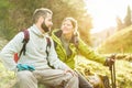 Young couple having a break after trekking in switzerland mountains - Happy people enjoying spring vacation - Hiking and healthy Royalty Free Stock Photo