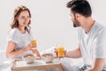 young couple having breakfast in bed in morning together Royalty Free Stock Photo