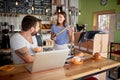 Young couple having breakfast and fun in coffee shop that they are about to open. starting business concept