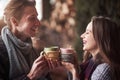 Young couple having breakfast in a romantic cabin outdoors in winter. Winter holiday and vacation. Christmas couple of