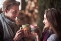 Young couple having breakfast in a romantic cabin outdoors in winter. Winter holiday and vacation. Christmas couple of