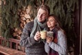 Young couple having breakfast in a romantic cabin outdoors in winter. Winter holiday and vacation. Christmas couple of