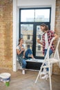 Young couple having coffee after painting the walls Royalty Free Stock Photo