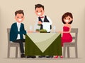 Young couple having dinner in a restaurant. Man and woman sitting at the table, the waiter shows the wine. Royalty Free Stock Photo