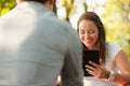 Young couple having fun on a bench in park while socializing over web Royalty Free Stock Photo